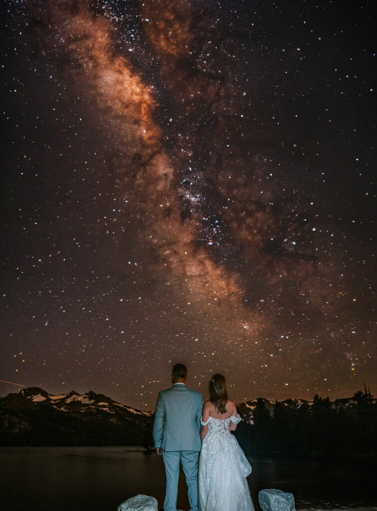 bride and groom and night sky with milky way at caples lake elopement wedding near kirkwood and lake tahoe
