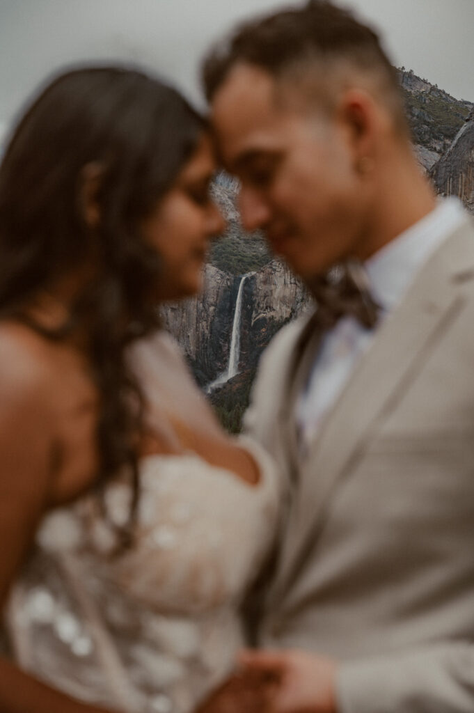 Bride and Groom with view of Bridal Veil Falls in Yosemite