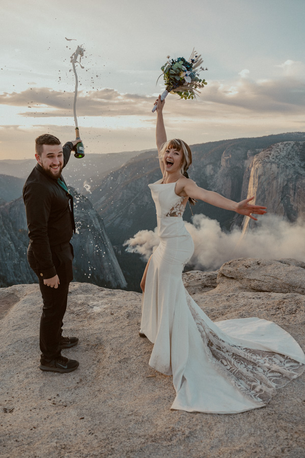 Yosemite Elopement bride and groom popping champagne at Taft Point