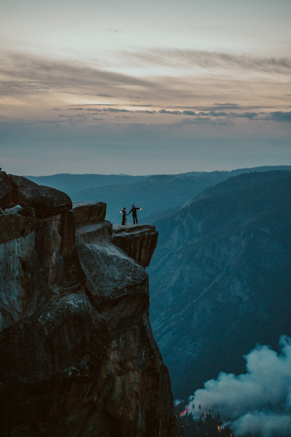 Yosemite Elopement bride and groom at Taft Point with lanterns and fire and smoke