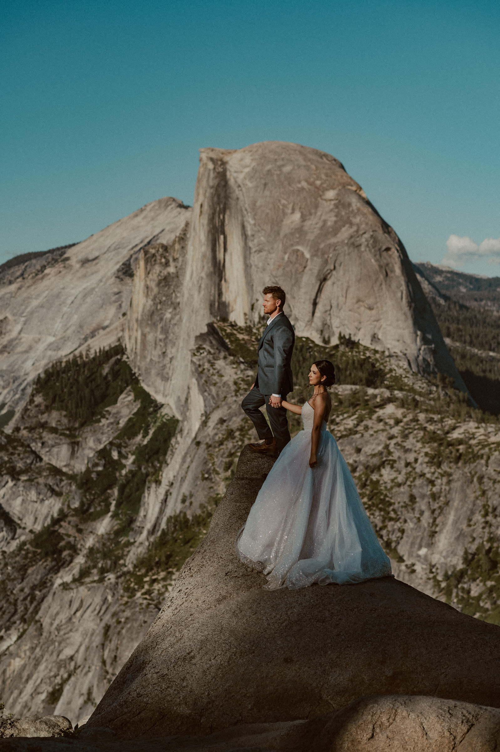 bride and groom who just eloped in Yosemite enjoy the views at Glacier Point