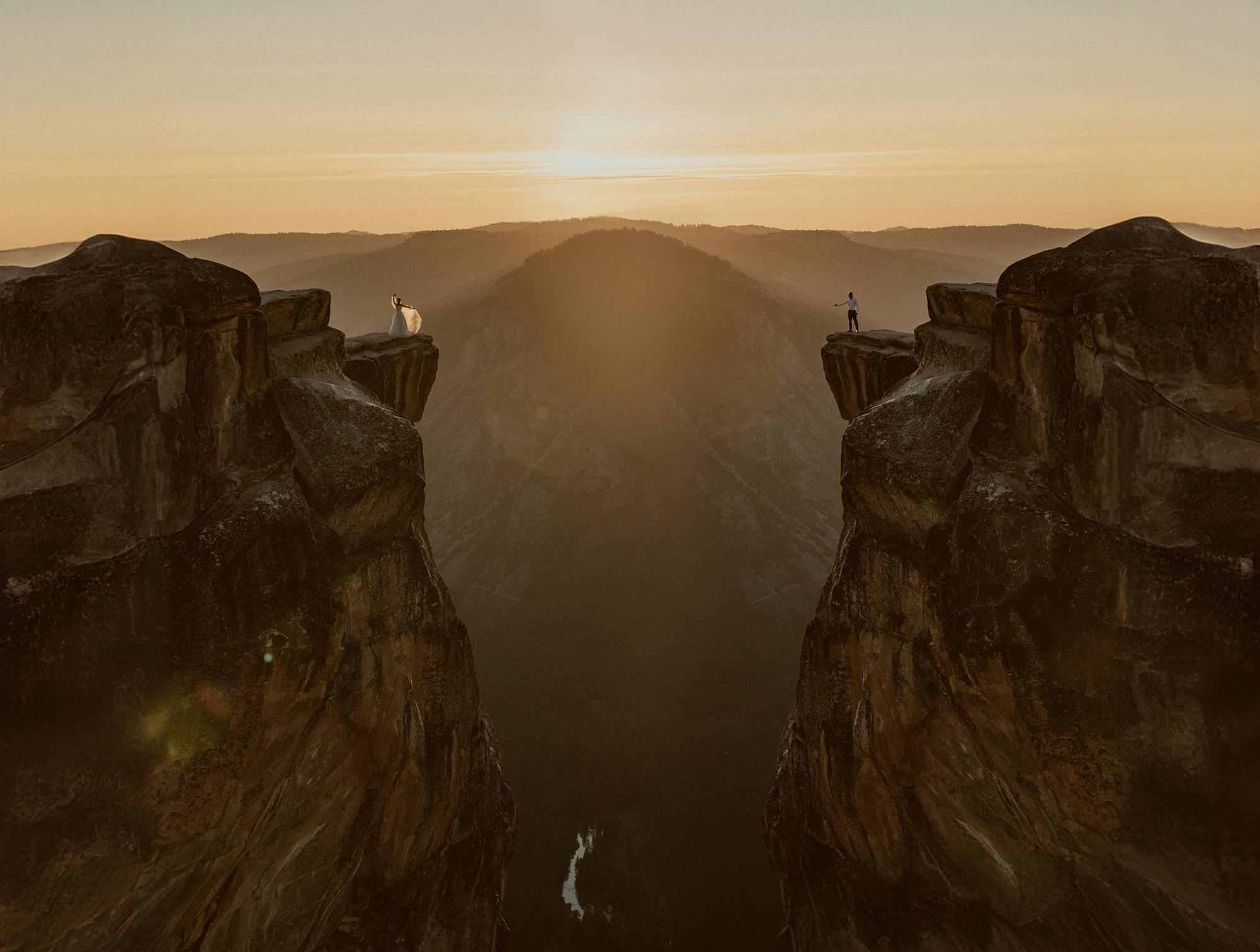 Taft Point Elopement Bride and groom reaching towards each other over Taft Point in Yosemite National Park