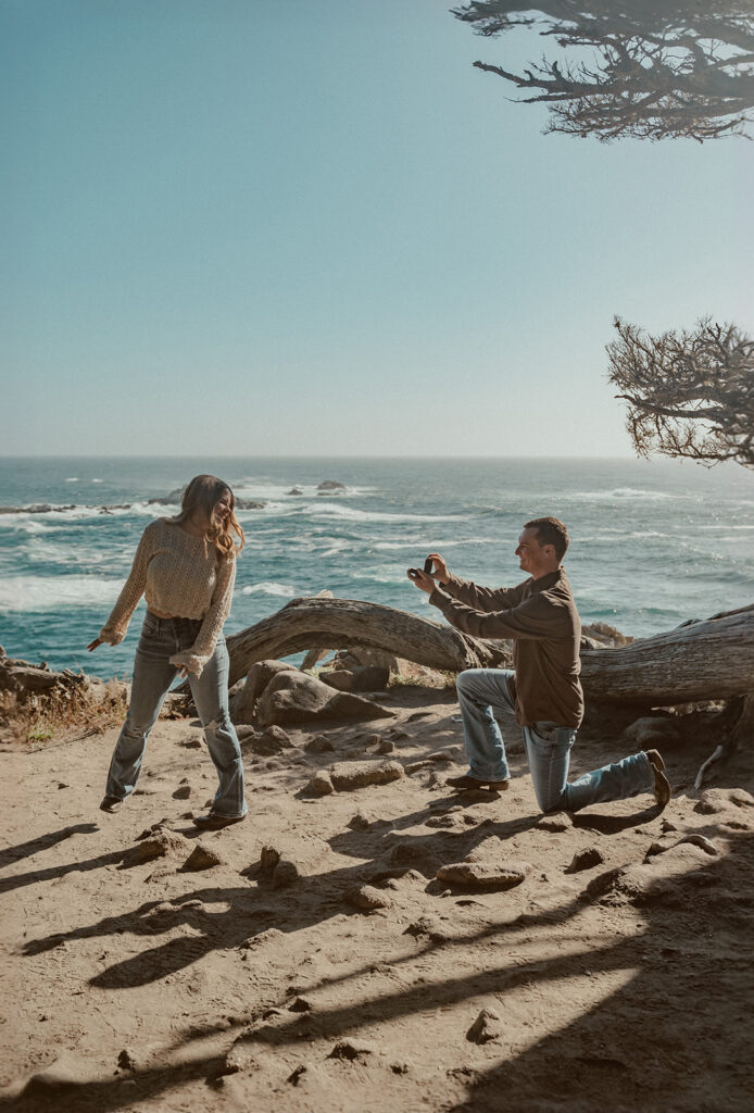 big sur proposal man gets down on one knee with coast in the background