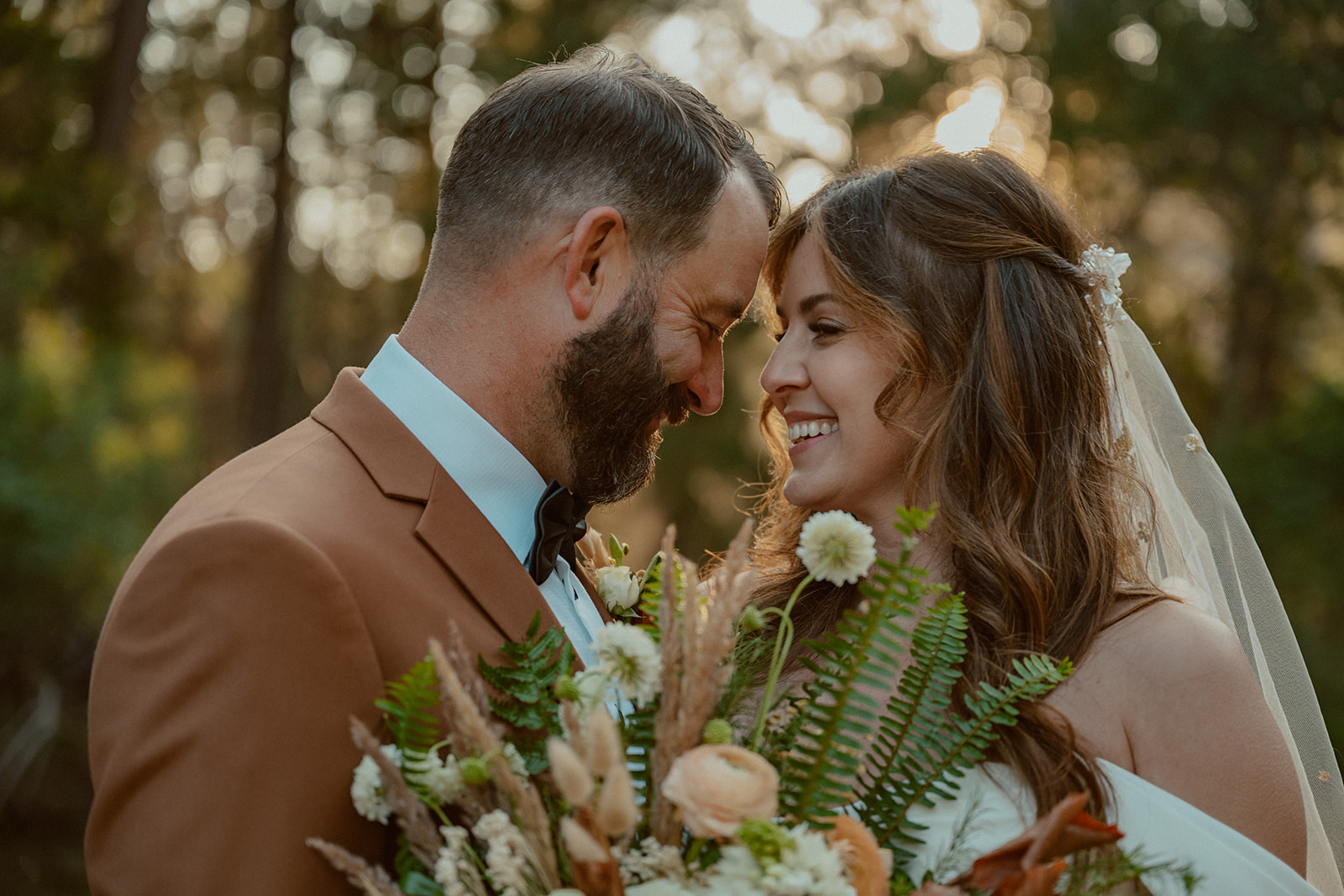 bride and groom laugh during their yosemite elopement at cathedral beach